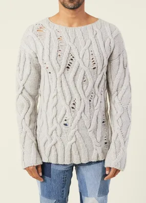 OVERSIZED DISTRESSED CABLE-KNIT SWEATER