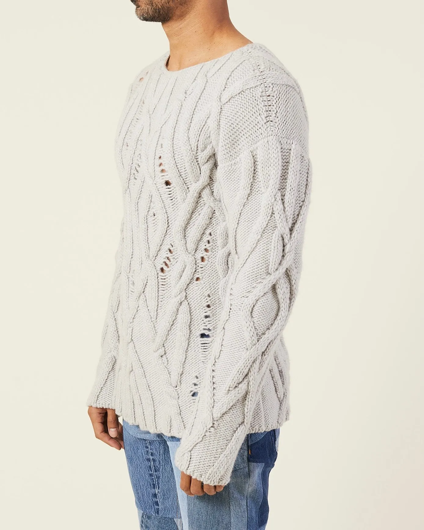 OVERSIZED DISTRESSED CABLE-KNIT SWEATER